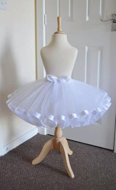 Stunning White Tutu Skirt, This beautiful white tutu skirt has been made with 2 layers of top quality soft tulle, with a lovely ribbon trim & a beautiful ribbon bow to match, which any princess would love! Stunning for any occasion All our lovely creations are CE & UKCA Tested. All our lovely tutu skirts are made to order. PLEASE BE AWARE that shades of tulle & ribbon may slightly differ from those illustrated due to the dying process  Your very welcome to follow us on our Facebook, Instagram & Professional Ballet Tutu, White Organza Tutu Dress, White Organza Dress For Birthday, Princess Tutu Dress For Costume Party, Princess Tutu Dress With Tulle Skirt For Costume Party, Princess Style Tutu Dress For Costume Party, Princess Tulle Skirt With Ruffles, Princess Style Tulle Skirt With Ruffles, White Organza Tutu Dress With Ruffles