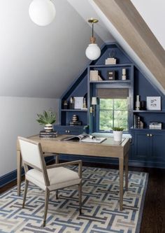 an attic office with blue painted walls and built - in shelving