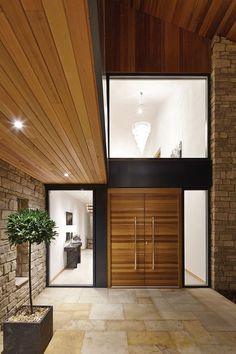 the entrance to this modern house is made from wood