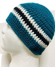 a white mannequin head wearing a blue and black knitted hat