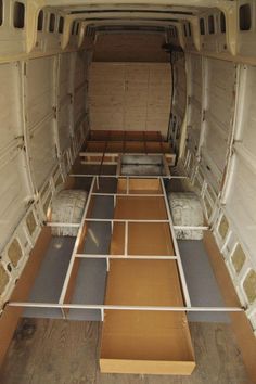 the interior of an empty van with multiple mattresses