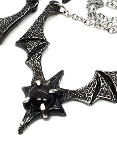 Made to Order! Dramatic, imposing and vampiric as you are, this bat wing necklace will complete your nocturnal ensemble. Stalk the halls of your dwelling or favorite events and capture the attention of your fellow night creatures with its unique design, sculpted in our studio. The pendant is cast in lead free pewter by hand and weathered, then set with a glass or stone cabochon. The chain is accented with hand beaded elements for a finishing touch. It can be layered with one of my rosary chains, Vampire Style Necklaces For Halloween Cosplay, Black Fantasy Necklaces For Parties, Gothic Horned Jewelry For Halloween, Black Jewelry For Halloween Fantasy Events, Black Gothic Jewelry For Fantasy Events, Black Gothic Necklace For Fantasy Events, Gothic Black Necklace For Fantasy Events, Black Metal Fantasy Necklace, Black Metal Jewelry For Fantasy Events