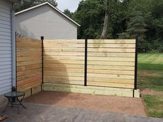 a wooden fence next to a house