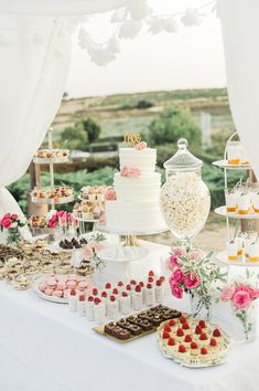 a table topped with lots of cakes and desserts