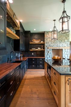 a kitchen with wooden floors and black cabinets