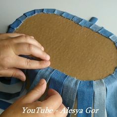 someone is making a blue and brown pillow out of old denims, with the words youtube - alesya gor on it