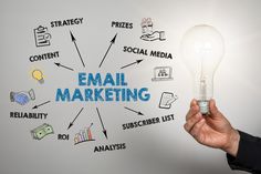 a person holding a light bulb with the word email marketing written on it in front of them