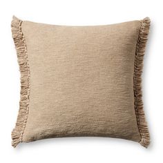 a beige pillow with fringes on the front and back of it, against a white background