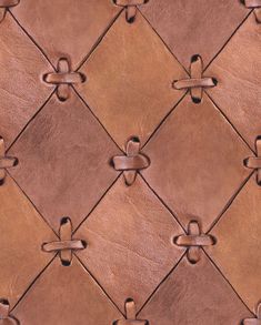 an up close view of a leather textured surface with rivets and knots