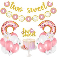 a birthday party with donuts, cake and balloons in the shape of two rings