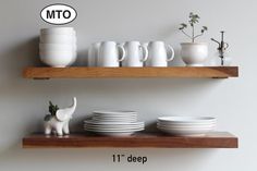 the shelf is full of white dishes and cups