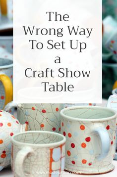 the wrong way to set up a craft show table with mugs and plates on it