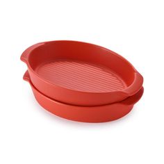 two red plastic dishes sitting on top of each other