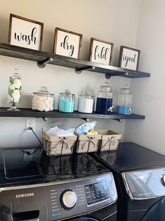 a washer and dryer sitting next to each other in a room with shelves on the wall