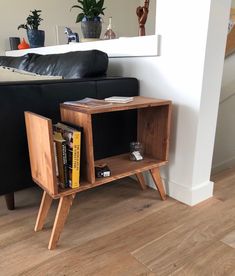 a small wooden table with books on it