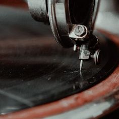 an old record player with its turntable spinning on it's side and the needle pointing up