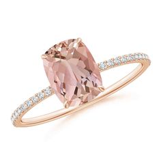 a pink diamond ring with diamonds on the band and an oval cut stone in the center