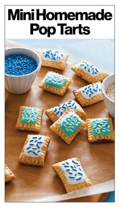 some cookies are sitting on a tray with blue and white frosting in the middle