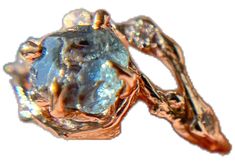 a close up view of a ring made out of gold and white opal stones