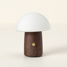 a small white mushroom lamp sitting on top of a table