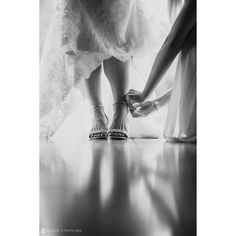 black and white photograph of two brides holding hands