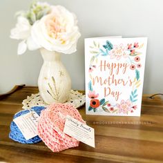 a mother's day card next to some crocheted doily and flowers