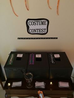 the costume contest table is set up with two boxes and three fake toothbrushes