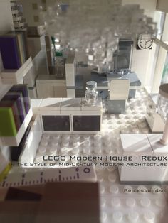 the lego model house is made up of many modern architecture pieces, including a kitchen and living room