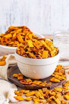 two bowls filled with cheetos sitting on top of a table