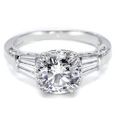 a diamond ring with three baguetts on the band and an oval center stone