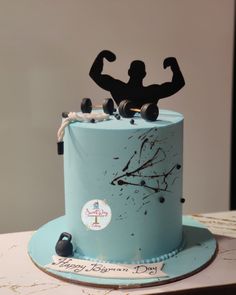 a birthday cake with a bodybuilding figure on top