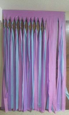 purple and blue curtains are hanging on the wall