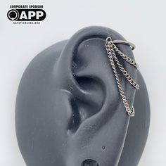 an ear is shown with chains attached to it