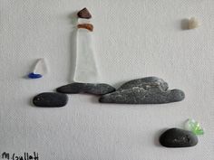 rocks and pebbles are arranged in the shape of a lighthouse