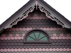 a pink and black house with an arched window