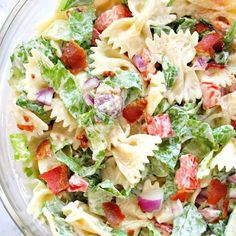 a bowl filled with pasta salad on top of a table