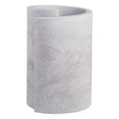 a white vase sitting on top of a table