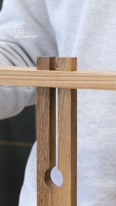 a close up of a wooden object with a person in the background looking at it