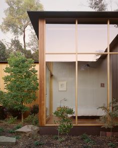 an image of a house with glass walls and wood trimmings on the outside