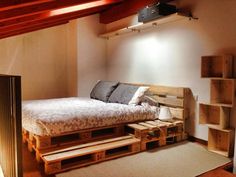 a bed made out of wooden pallets in a room