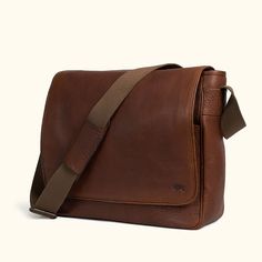 Crafted from the rich and textured full grains of buffalo hide, our limited edition Roosevelt Buffalo Leather Satchel showcases the deep and natural brown grains unique to each piece. With dimensions of 17" long and 13" high, it offers padded space for a 15" laptop screen display laptop (measured diagonally), additional storage under the flap, and an area to hold pens and accessories. Safeguard your valuables in the interior or exterior zipper pockets. The satchel's interior features our interio Mens Leather Satchel, Buffalo Jackson, Iron Hardware, Laptop Screen, Leather Satchel Bag, Buffalo Leather, Leather Messenger Bag, Brown Canvas, Leather Messenger