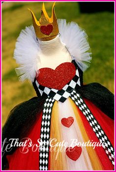 a close up of a dress with a crown on it's head and hearts