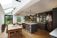 an open kitchen and dining room with skylights