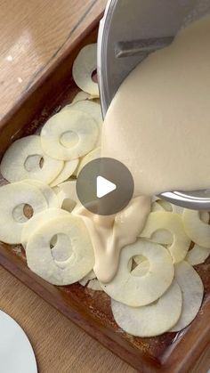 a person pouring sauce on some sliced apples