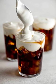 two glasses filled with ice cream sitting on top of a table