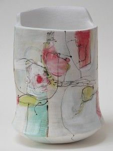 a white vase with red and green designs on it