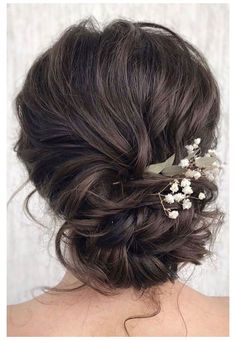 the back of a woman's head with flowers in her hair