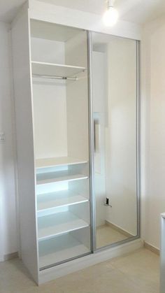 a walk in closet with glass doors and shelves