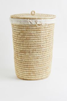 a large woven basket with a white lid