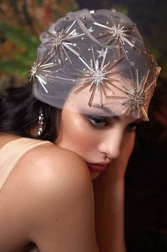 a woman wearing a silver hat with stars on it